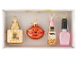 Set of cosmetic-themed Christmas ornaments: perfume, lips, lipstick, and nail polish.