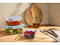Silvercrest glass containers with lids, filled with food, on a wooden countertop.