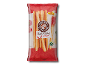 Packet of wheat breadsticks with a new recipe, shown with tomatoes and ham.