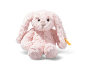 Pink plush bunny with long ears sitting on a white background.