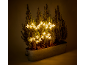 Garden decoration with LED star lights and fir trees in a metal planter.