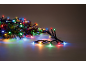 Multicolor Christmas string lights with fir branches.