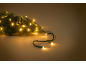 Warm, glowing Christmas lights on a pine branch.