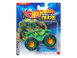 Green monster truck toy with large wheels in packaging, with a blue background.