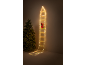 Illuminated Santa climbing a light-up ladder next to a Christmas tree.