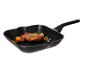 Black grill pan with grilled steak, mushrooms, and onions.