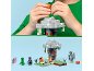 Child playing with a building block set featuring a tree, figures, and accessories.