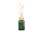 Winter Walk reed diffuser in a green glass bottle with wooden sticks.