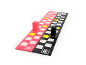 Pink and black wooden game pieces on a game board with numbers.