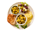 Plate of green and purple olives, feta cheese, lemon, and toasted bread.