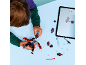 Child building a toy figure with digital instructions on a tablet.