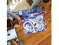 Two girls playing with a building toy advent calendar on a wooden table.