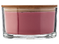 Red candle in a glass jar with a wooden lid.