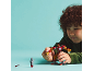 A child plays with a robot action figure and a minifigure against a blue background.