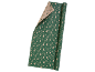 Roll of Christmas wrapping paper with fir trees and snowflakes on a green background.