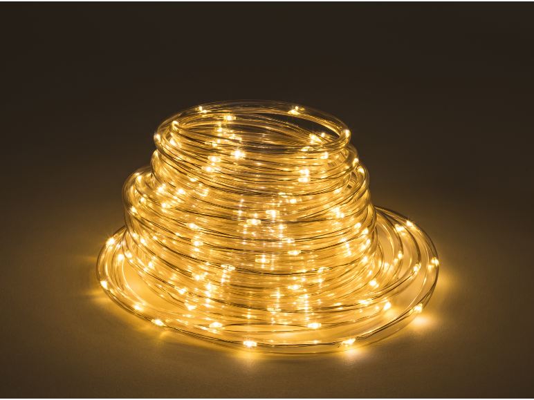 Spiral-coiled LED rope light with warm white light on a dark background.