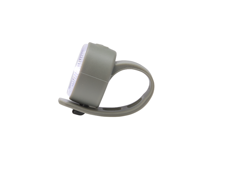 Grey bicycle light with white light on a black background.