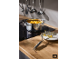Pot of mashed vegetables on a hob, with a potato masher on a plate