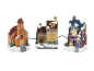 Three festive Christmas village houses with snow-covered roofs, including a church and a toy shop.