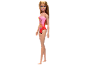 Blonde doll in a red and pink swimsuit with palm trees.