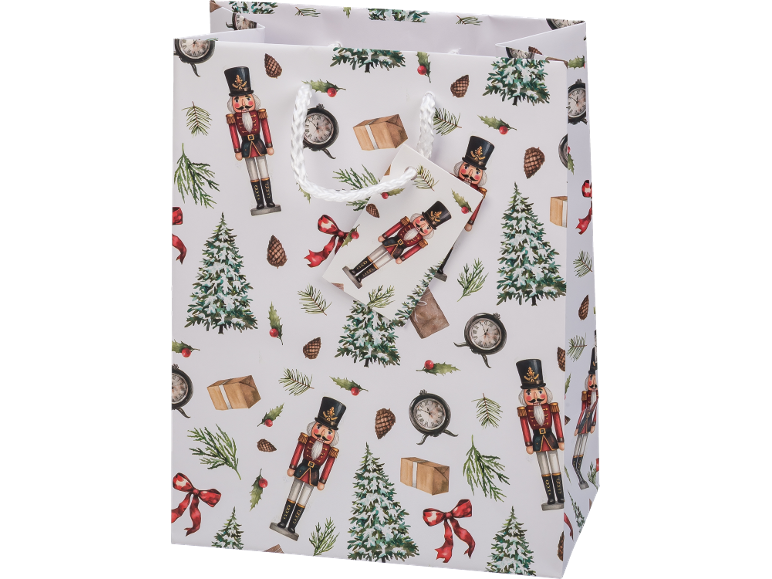 White Christmas gift bag with nutcrackers, Christmas trees, and clocks.