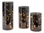 Three decorative glass cylinders with warm white LED fairy lights on a black background.
