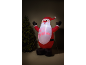 Inflatable Santa Claus with 'HO HO! CHRISTMAS' text, next to a Christmas tree.