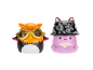 Two toy figurines: an owl with goggles and a purple octopus with a cat-eared hat.