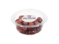 Kalamata olives with pits in a clear plastic container.