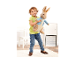 Smiling boy holding a large plush rabbit wearing a blue jacket.