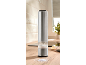Metal and plastic electric salt grinder with coarse salt on a wooden kitchen counter.