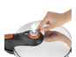 Hand adjusting the valve of a pressure cooker with steam escaping.