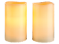 Two ivory-colored LED candles with a flickering light effect