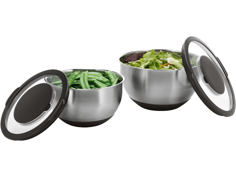 Two stainless steel bowls with lids, one with snap peas and the other with salad.
