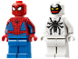Two toy figures, one red and blue superhero, and one white and black creature.