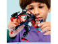 Boy playing with a black and red articulated robot action figure.