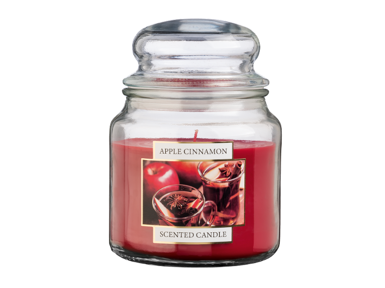 Apple cinnamon scented candle in a glass jar with a lid.