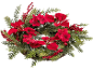 Christmas wreath with red poinsettia flowers, berries, and green foliage.
