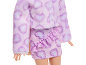 Doll in a pink fluffy jacket and skirt with hearts