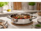 Stainless steel pot with stew on a kitchen counter.