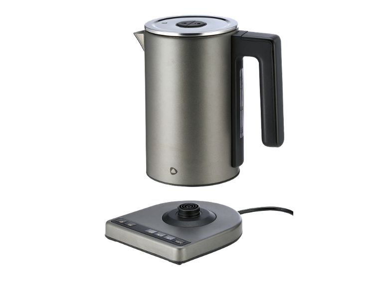 Grey electric kettle with temperature control base on black background.