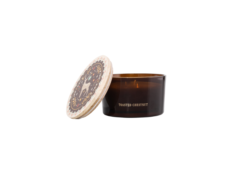 Toasted Chestnut scented candle in a brown glass with a decorated lid featuring a deer motif