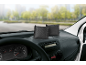 Two black dehumidifier pillows on a car dashboard.