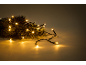 Warm Christmas lights on pine branches, creating a festive ambiance.