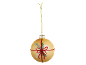 Golden Christmas bauble with a shimmering red ribbon and pine branches.