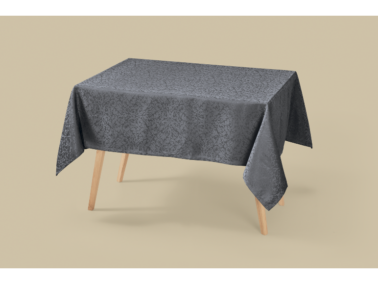 Grey damask pattern tablecloth on a wooden table