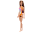 Doll in an orange and pink swimsuit with a floral pattern.