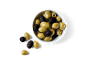 Green and black olives in a white bowl on a black background.