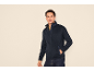 Men's dark blue zip-up fleece jacket with a yellow T-shirt and jeans.