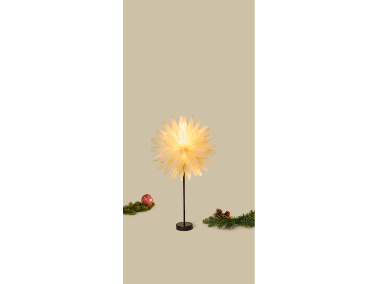 Decorative table lamp in the shape of an illuminated paper star.